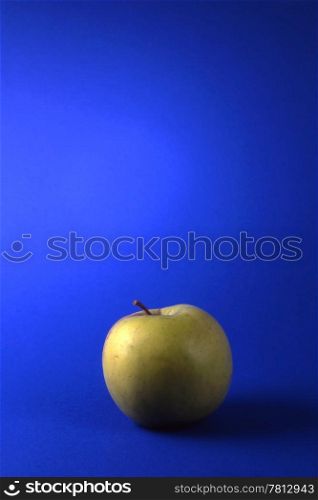 One green apples isolated on blue background