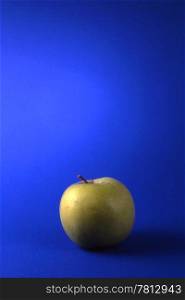 One green apples isolated on blue background