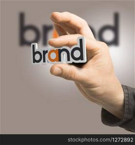 One hand holding the word brand over a beige background. Branding concept. The image is a composition between 2D illustration, 3D rendering and photography. Brand - Company Identity