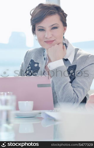 one happy young business woman working on laptop computer at group team meeting at modern office