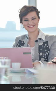 one happy young business woman working on laptop computer at group team meeting at modern office