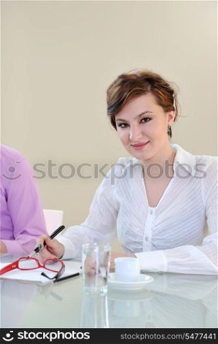 one happy young business woman working on laptop computer at group team meeting at modern office
