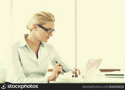 one happy young business woman working on laptop computer at group team meeting at modern office