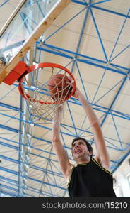 one healthy young man play basketball game in school gym indoor