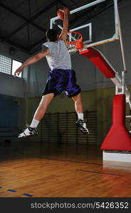 one healthy young man play basketball game in school gym indoor