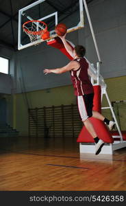 one healthy young man play basketball game in school gym indoor