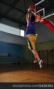 one healthy young man play basketball game in school gym indoor