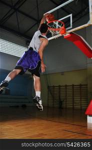 one healthy young man play basketball game in school gym indoor