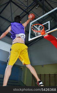 one healthy young man play basketball game in school gym indoor