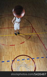 one healthy young man play basketball game in school gym indoor