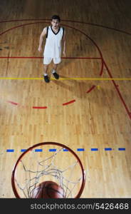 one healthy young man play basketball game in school gym indoor