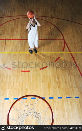 one healthy young man play basketball game in school gym indoor