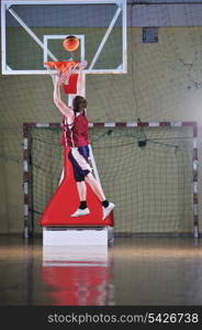 one healthy young man play basketball game in school gym indoor