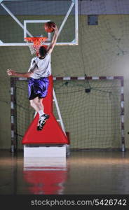 one healthy young man play basketball game in school gym indoor