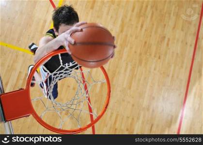 one healthy young man play basketball game in school gym indoor