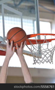 one healthy young man play basketball game in school gym indoor