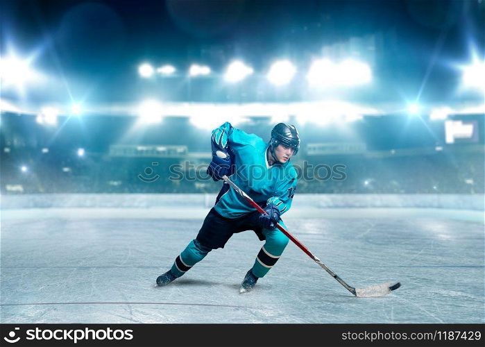 One hockey player skating with stick on ice arena, spotlights on background. Male person in helmet, gloves and uniform playing game