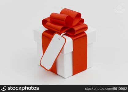 One Holiday gift with tag on white background