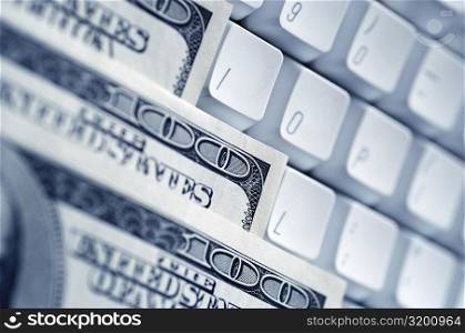 One hundred dollar bills on a computer keyboard