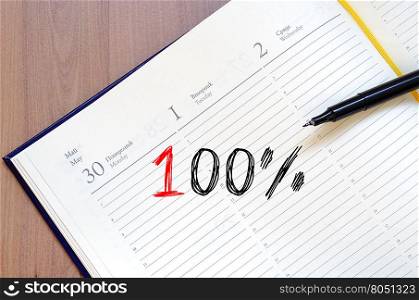One hundred percent symbol text concept write on notebook