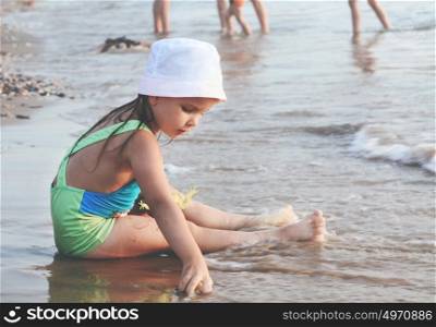 One Little Cute Pensive Girl Playing On A Sand Beach