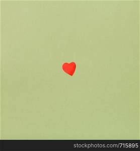 one little heart cut out of red paper on background from Dark Olive Green pastel paper