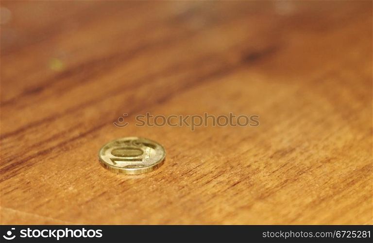 One lonely coin laying on the table