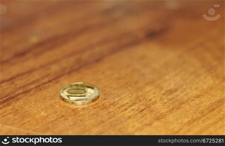 One lonely coin laying on the table