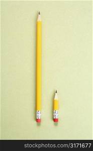 One long pencil and one short pencil placed side by side in comparison.