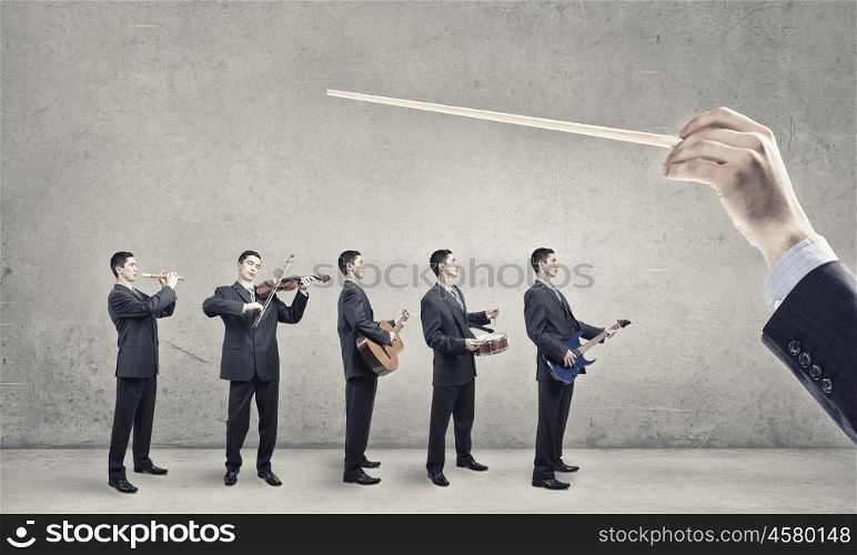 One man band. Man orchestra in suit playing different music instruments