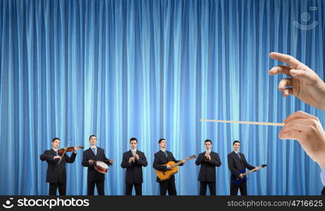 One man band. Man orchestra in suit playing different music instruments