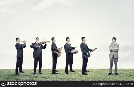 One man band. Man orchestra in suit playing different music instruments