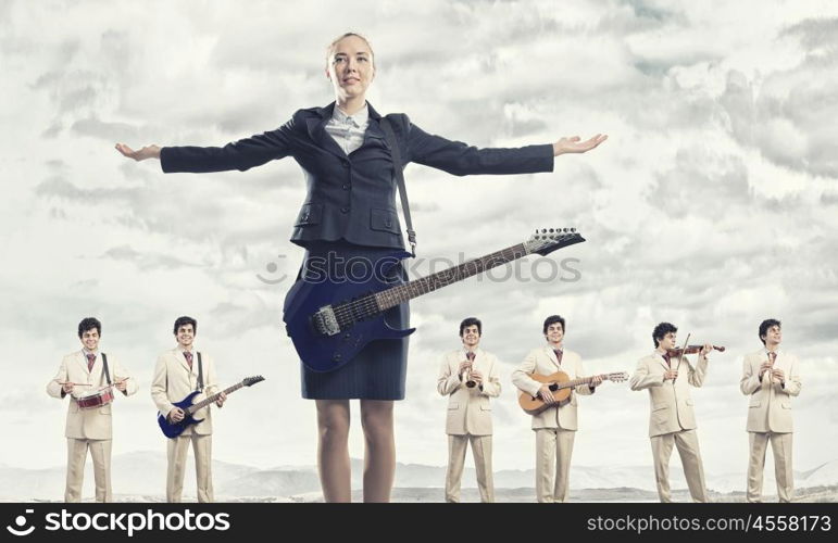 One man band. Man orchestra playing different music instruments and woman leader