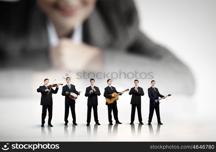 One man band. Man orchestra playing different music instruments and woman leader