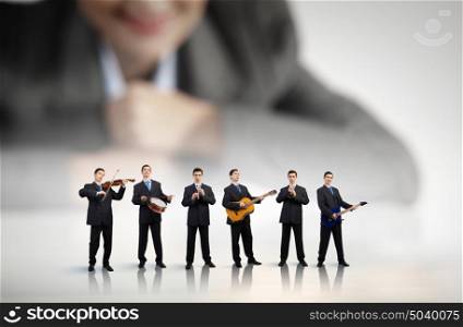 One man band. Man orchestra playing different music instruments and woman leader