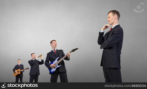 One man band. Young man in suit and people playing different music instruments