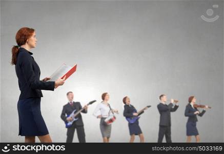 One man band. Young woman in suit playing different music instruments