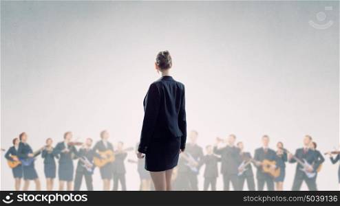One man band. Young woman standing with back and people playing different music instruments