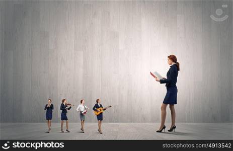 One man band. Young woman with book and playing different music instruments