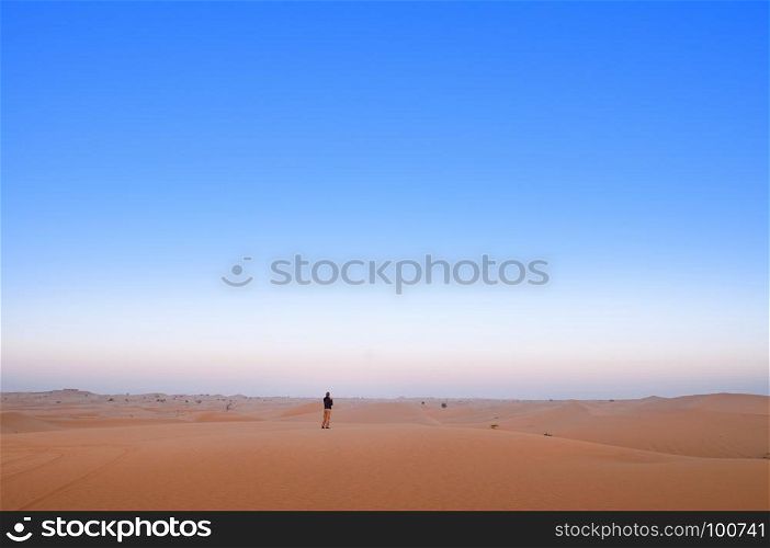 One man is standing alone in Al Wathba desert. Abu Dhabi.
