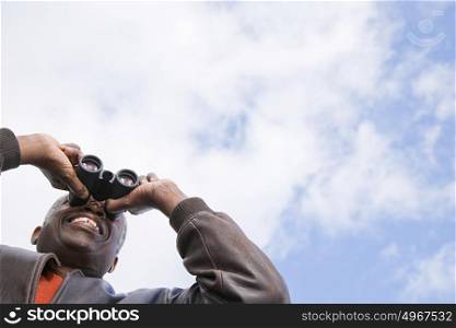 One man looking through binoculars