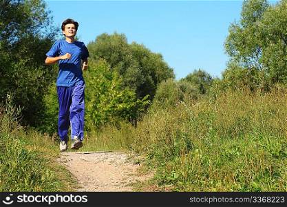 one man wearing sporty clothes is running along path outdoor