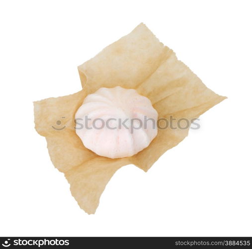 One meringue in the packaging paper isolated on white background