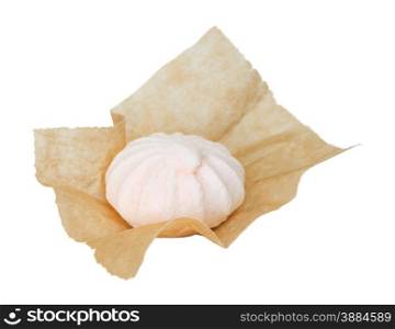 One meringue in the packaging paper isolated on white background