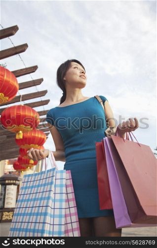 One Mid Adult Woman With Shopping Bags