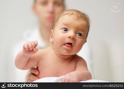 One month old newborn baby with his mother