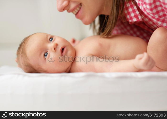 One month old newborn baby with his mother