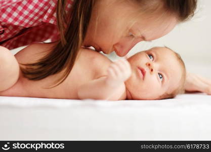 One month old newborn baby with his mother