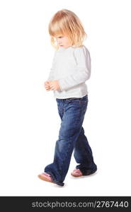 one nice little girl wearing jeans and shirt is walking. isolated.