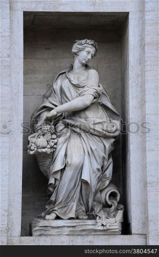 One of the statues on the Palazzo Poli in Rome, Italy